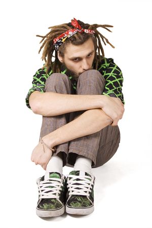 young dreadlock man sits isolatedの写真素材