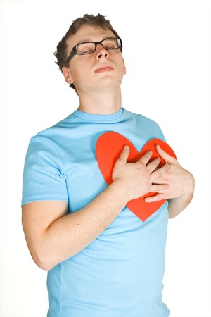 man in blue shirt pressing to bosom red decor paper heart isolated on whiteの写真素材