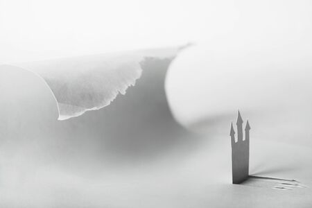 abstract paper background with castle and big ocean wave, danger conceptの写真素材