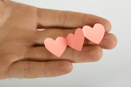 human holding little paper cutout hearts, love conceptの写真素材