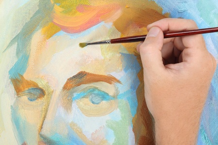man hand painting multicolored abstract portrait of maleの写真素材