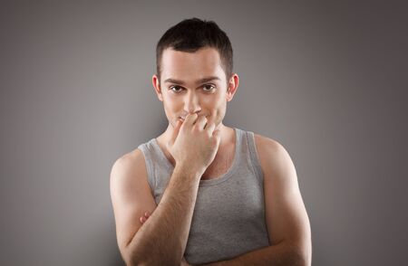 Handsome young male fashion model, wearing in grey singlet  Studio shotの写真素材