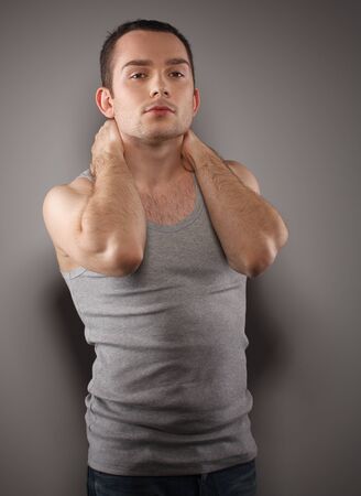 Handsome young male fashion model, wearing in grey singlet  Studio shotの写真素材