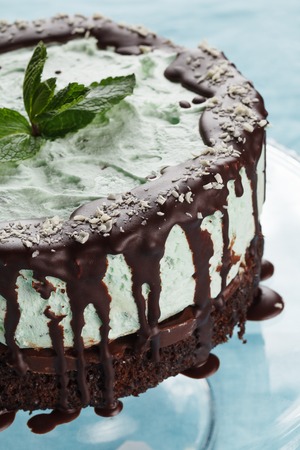 Whole cake of mint and chocolate on salverの写真素材