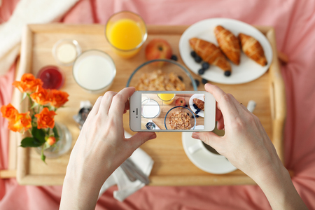 Overhead view of breakfast served in bed on wooden trayの写真素材