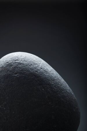 Close-up of grey stone over grey background