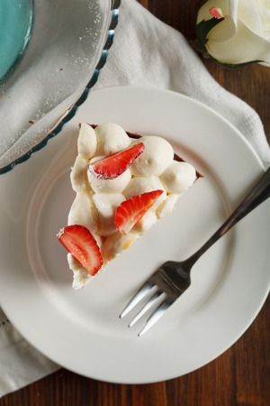 Close-up view of piece of tart with strawberries. Rustic style