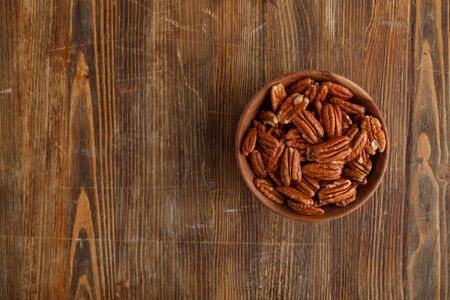 Bowl of pecan nuts. Copy space