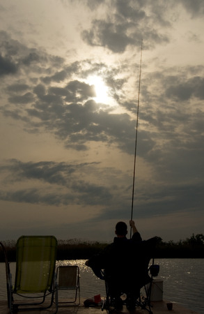 Man fishing on the lakeの写真素材