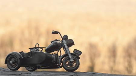 Close-up of miniature toy motorcycle on natural backgroundの写真素材
