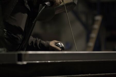 Industrial Worker at the factory welding closeup