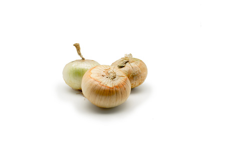 Three Onion vegetable bulbs isolated on white backgroundの写真素材