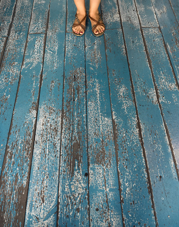 Feet on blue wooden backgroundの写真素材