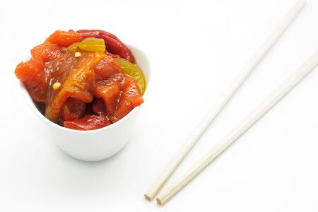 Roasted peppers and chopsticks on white backgroundの写真素材