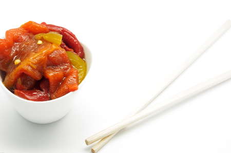 Roasted pepper salad and chopsticks on white background. Fusion styleの写真素材