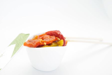 Close up of roasted pepper salad on white background.の写真素材