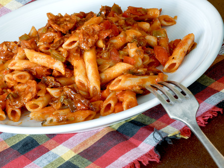 Macaroni with tomato sauce, sausage and pepper.の写真素材