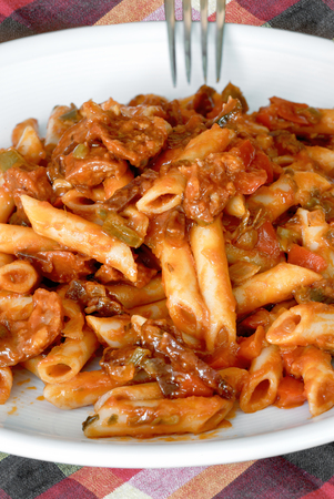 Macaroni with tomato sauce, sausage and pepper.の写真素材