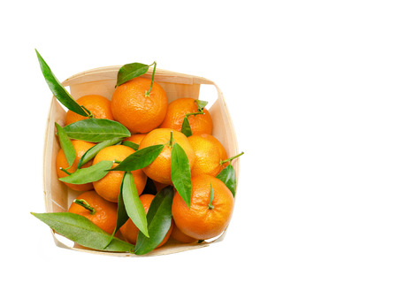 Tangerines with leaves in wooden box isolated on white background with copy spaceの写真素材
