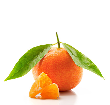 Tangerine with leaves and slices isolated on white background.の写真素材