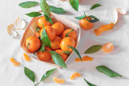Tangerines on white tableclothの写真素材
