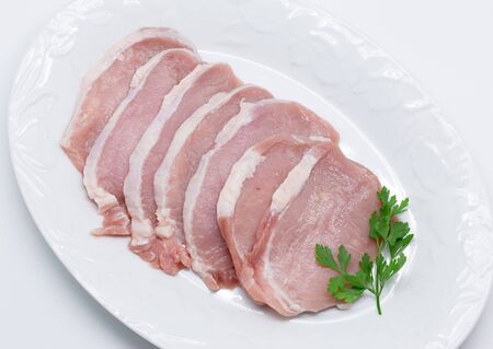 Raw pork meat isolated on whiteの写真素材