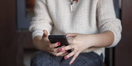Girl typing on mobile phoneの写真素材