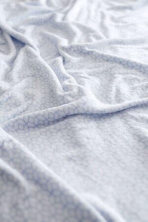 Comfortable white and blue bed sheet background