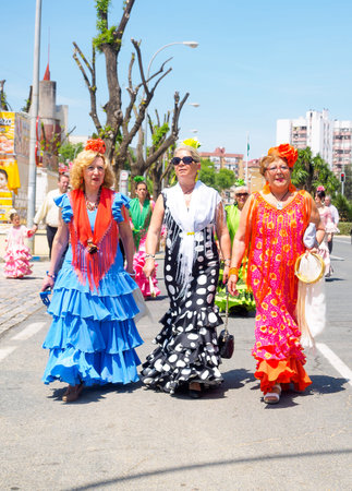 Seville, Spain - April 23, 2015: Women dressed in traditional costumes at the Seville's April Fair. The Seville Fair "Feria de abril de Sevilla" is one of most important celebration of the city, it begins one or two week after easter Holy Weekのeditorial素材