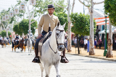Seville, Spain - April 28, 2015: Horse rider taking a walk by the fair of Seville. The Seville Fair "Feria de abril de Sevilla" is one of most important celebration of the city, it begins one or two week after easter Holy Weekのeditorial素材