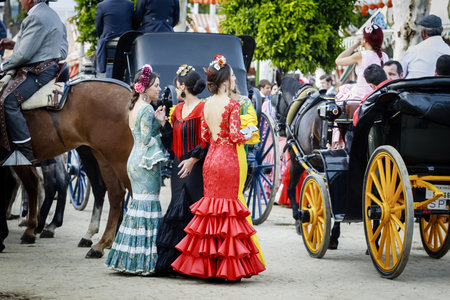 Seville, Spain - April 28, 2015: Young women wearing traditional flamenco dress at the April Fair Seville .のeditorial素材