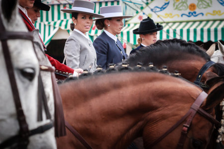 Seville, Spain - April 29, 2015: Beautiful amazons in traditional dress riding at the April Fair Seville. The Seville Fair "Feria de abril de Sevilla" is one of most important celebration of the city, it begins one or two week after easter Holy Weekのeditorial素材