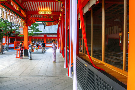 Kyoto, Japan- July 21,2015 : Women in kimono (Japanese dress) ringing bells praying for good luck, family safety etc in front of the main hall of the Fushimi Inari Shrine, Kyoto, Japanのeditorial素材
