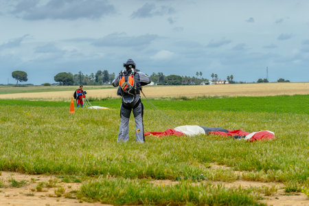 Seville, Spain - May 7, 2016: Skydiver unfasten his parachute after landing. Skydive Spain is the skydiving center located at La Juliana Aerodrome, about 20 km southwest of Seville, Spain. At Skydive Spain they fly up to 15,000ft, the highest altitude in のeditorial素材