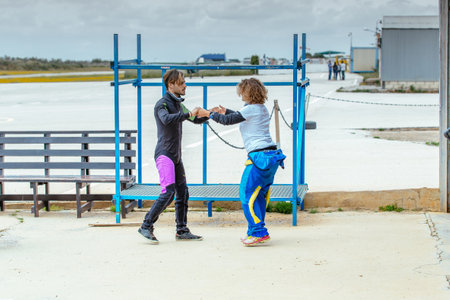 Seville, Spain - May 7, 2016: Skydiving instructor teaches her the correct skydiving position before jumping. Skydive Spain is the skydiving center located at La Juliana Aerodrome, about 20 km southwest of Seville, Spain. At Skydive Spain they fly up to 1のeditorial素材