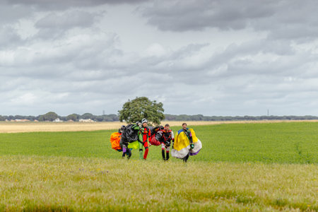 Seville, Spain - May 7, 2016: Skydivers carries a parachute after landing. Skydive Spain is the skydiving center located at La Juliana Aerodrome, about 20 km southwest of Seville, Spain. At Skydive Spain they fly up to 15,000ft, the highest altitude in Euのeditorial素材