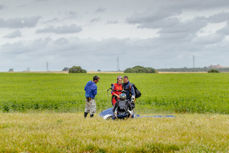 Seville, Spain - May 7, 2016: Skydiver Taking a Picture of Tandem after landing. Skydive Spain is the skydiving center located at La Juliana Aerodrome, about 20 km southwest of Seville, Spain. At Skydive Spain they fly up to 15,000ft, the highest altitudeのeditorial素材