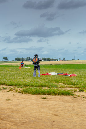 Seville, Spain - May 7, 2016: Skydiver unfasten his parachute after landing. Skydive Spain is the skydiving center located at La Juliana Aerodrome, about 20 km southwest of Seville, Spain. At Skydive Spain they fly up to 15,000ft, the highest altitude in のeditorial素材