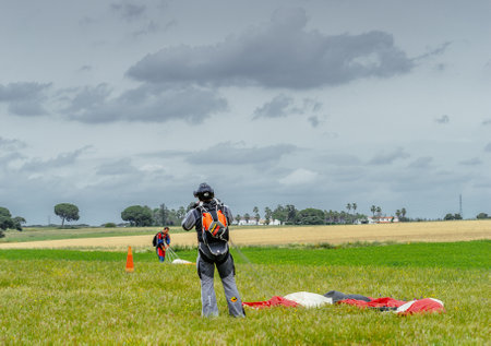Seville, Spain - May 7, 2016: Skydiver unfasten his parachute after landing. Skydive Spain is the skydiving center located at La Juliana Aerodrome, about 20 km southwest of Seville, Spain. At Skydive Spain they fly up to 15,000ft, the highest altitude in のeditorial素材