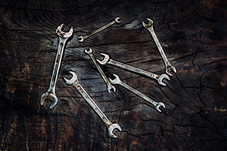 Set of spanners on a dark wooden background.の写真素材