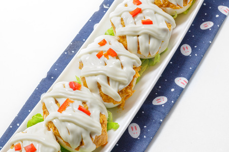 Stuffed eggs with tuna, tomato, mayonnaise and red pepper on white backgroundの写真素材