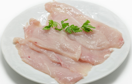 Raw chicken meat on white dishの写真素材