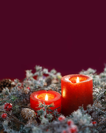 Christmas candles on a red background. Space for textの写真素材
