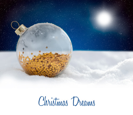Christmas decoration glass ball at snowy nightの写真素材