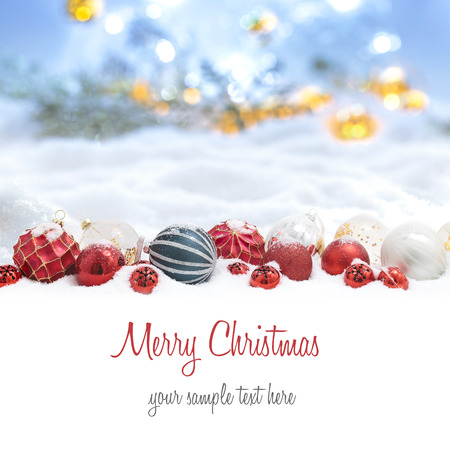 Many christmas balls  in the snow and defocused lightsの写真素材