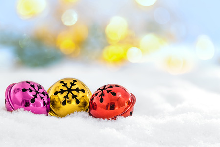 Christmas jingle bells in the snow and defocused lightsの写真素材