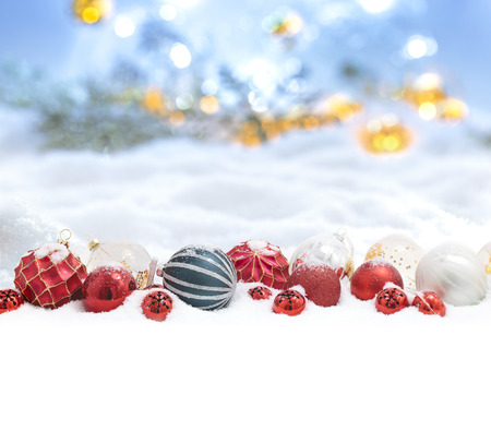 Many christmas balls  in the snow and defocused lightsの写真素材