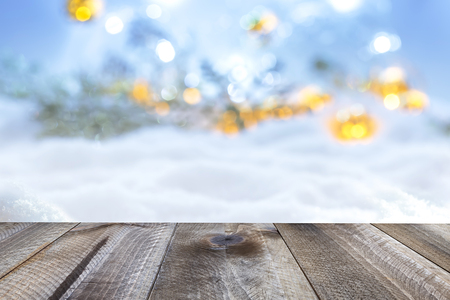 Winter christmas background with wooden table and blur abstract lightsの写真素材
