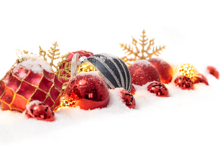 Many christmas balls in the snow isolated on whiteの写真素材