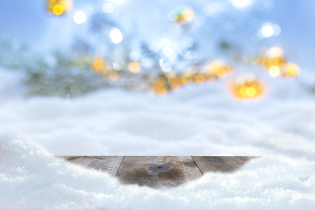 Winter christmas background with wooden table and blur abstract lightsの写真素材